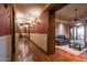 Long hallway with hardwood floors and access to other rooms at 865 E Monte Vista Trl, Wickenburg, AZ 85390
