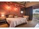 Bright bedroom with a king-size bed and access to patio at 865 E Monte Vista Trl, Wickenburg, AZ 85390