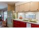 Kitchen features red and beige cabinets and double sink at 8421 E Main St # 106, Mesa, AZ 85207