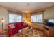Living room with red couch and glass top coffee table at 8421 E Main St # 106, Mesa, AZ 85207