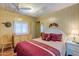 Bright bedroom with double bed, dresser, and ceiling fan at 8421 E Main St # 106, Mesa, AZ 85207