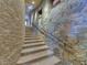 Stone staircase with metal railing, leading to upper levels of the home at 11108 E Mariola Way, Scottsdale, AZ 85262