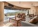 Living room with stone fireplace, large windows and mountain views at 11108 E Mariola Way, Scottsdale, AZ 85262
