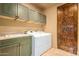Laundry room with built-in cabinets and a sink at 11108 E Mariola Way, Scottsdale, AZ 85262