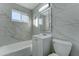 Clean bathroom with marble-look tile, vanity, and a bathtub at 4522 N 14Th Ave, Phoenix, AZ 85013