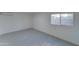 Simple bedroom with window, wood-look floors, and AC unit at 4522 N 14Th Ave, Phoenix, AZ 85013