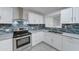 White shaker cabinets, granite countertops, and stainless steel appliances at 4522 N 14Th Ave, Phoenix, AZ 85013