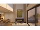 Modern kitchen with island, fireplace, and patio access at 4849 N Camelback Ridge Rd # B301, Scottsdale, AZ 85251
