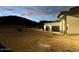 Modern house exterior at dusk, featuring a two-car garage and attractive exterior lighting at 3525 S Kings Ranch Ct # 4, Gold Canyon, AZ 85118