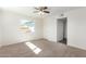 Bright bedroom with carpeted floor, ceiling fan and window at 1401 E Osborn Rd, Phoenix, AZ 85014