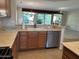 Kitchen with sink, dishwasher and view into living room at 17626 W Calistoga Dr, Surprise, AZ 85387
