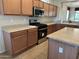 Kitchen with stainless steel appliances and wood cabinets at 17626 W Calistoga Dr, Surprise, AZ 85387