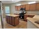 Kitchen with island, stainless steel appliances, and wood cabinets at 17626 W Calistoga Dr, Surprise, AZ 85387