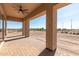 Covered patio with brick pavers and ceiling fan at 31712 N 169Th Ave, Surprise, AZ 85387