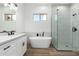 Elegant bathroom featuring a freestanding tub and a walk-in shower at 31712 N 169Th Ave, Surprise, AZ 85387