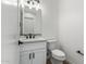 Modern bathroom with white vanity, quartz countertop, and black accents at 31712 N 169Th Ave, Surprise, AZ 85387