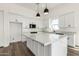 Bright kitchen with white cabinets, quartz countertops, and pendant lighting at 31712 N 169Th Ave, Surprise, AZ 85387