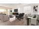 Bright living room with dining area, hardwood floors, and modern furniture at 17227 W Middlebury St, Surprise, AZ 85388