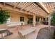 Covered patio with pergola, seating area, and built-in grill at 27 N Agua Fria Ln, Casa Grande, AZ 85194