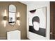 Modern powder room with floating vanity and statement art at 41851 N 112Th Pl, Scottsdale, AZ 85262
