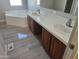 Bathroom with double vanity and corner tub at 48230 W Gaveston Ct, Maricopa, AZ 85139