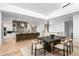 Modern dining area with dark wood table, light chairs, and kitchen views at 37200 N Cave Creek Rd # 2124, Scottsdale, AZ 85262