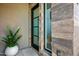 Modern front door with glass panels and black frame at 37200 N Cave Creek Rd # 2124, Scottsdale, AZ 85262
