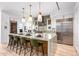 Gourmet kitchen with large island, stainless steel appliances, and green barstools at 37200 N Cave Creek Rd # 2124, Scottsdale, AZ 85262