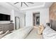 Main bedroom with king bed, large mirror, and en-suite bathroom access at 37200 N Cave Creek Rd # 2124, Scottsdale, AZ 85262