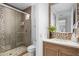 Contemporary bathroom with single vanity, glass shower, and pebble floor at 37200 N Cave Creek Rd # 2124, Scottsdale, AZ 85262