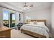 Guest bedroom with king-size bed, balcony access, and golf course views at 37200 N Cave Creek Rd # 2124, Scottsdale, AZ 85262
