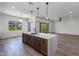 Open concept kitchen with island and views into the living area at 723 N Moon Rd, Apache Junction, AZ 85119