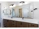 Double vanity bathroom with modern light fixtures and large mirror at 723 N Moon Rd, Apache Junction, AZ 85119