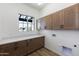 Bright laundry room with ample cabinetry and countertop space at 723 N Moon Rd, Apache Junction, AZ 85119