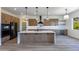 Modern kitchen with a large island, custom cabinetry, and quartz countertops at 723 N Moon Rd, Apache Junction, AZ 85119