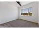 Bright bedroom with carpet flooring and large window at 723 N Moon Rd, Apache Junction, AZ 85119