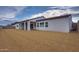 Spacious backyard with desert landscaping and covered patio at 17448 W Carlisle Dr, Surprise, AZ 85388