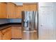 Stainless steel refrigerator in a kitchen with light wood cabinets at 18449 W Piedmont Rd, Goodyear, AZ 85338