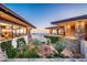 Landscaped courtyard with stone features and mountain backdrop at 11070 E Rolling Rock Dr, Scottsdale, AZ 85262