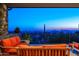 Stunning sunset view from a covered patio with seating at 11070 E Rolling Rock Dr, Scottsdale, AZ 85262