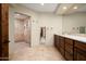 Double vanity bathroom with a large mirror and a walk-in shower at 11070 E Rolling Rock Dr, Scottsdale, AZ 85262