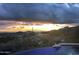 Stunning sunset view from a luxurious infinity pool at 11070 E Rolling Rock Dr, Scottsdale, AZ 85262