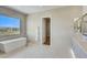 Bright bathroom with freestanding tub and walk-in closet at 13188 E Desert Holly Dr, Scottsdale, AZ 85255