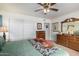 Comfortable bedroom with double bed, wooden dressers, and ceiling fan at 8351 E Monte Ave, Mesa, AZ 85209