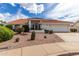Single-story house with a two-car garage and desert landscaping at 8351 E Monte Ave, Mesa, AZ 85209