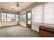 Sunroom with tile floor, ceiling fan, and access to backyard at 8351 E Monte Ave, Mesa, AZ 85209