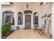 Front entry with a tiled floor, seating area, and wrought iron security door at 8351 E Monte Ave, Mesa, AZ 85209