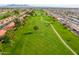 Aerial view of a golf course community with homes and lush greens at 8351 E Monte Ave, Mesa, AZ 85209