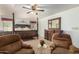Main bedroom with a large bed, two armchairs and ceiling fan at 8351 E Monte Ave, Mesa, AZ 85209