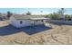 Aerial view of the backyard featuring a covered patio and surrounding desert landscape at 4030 N Palm Cir, Eloy, AZ 85131